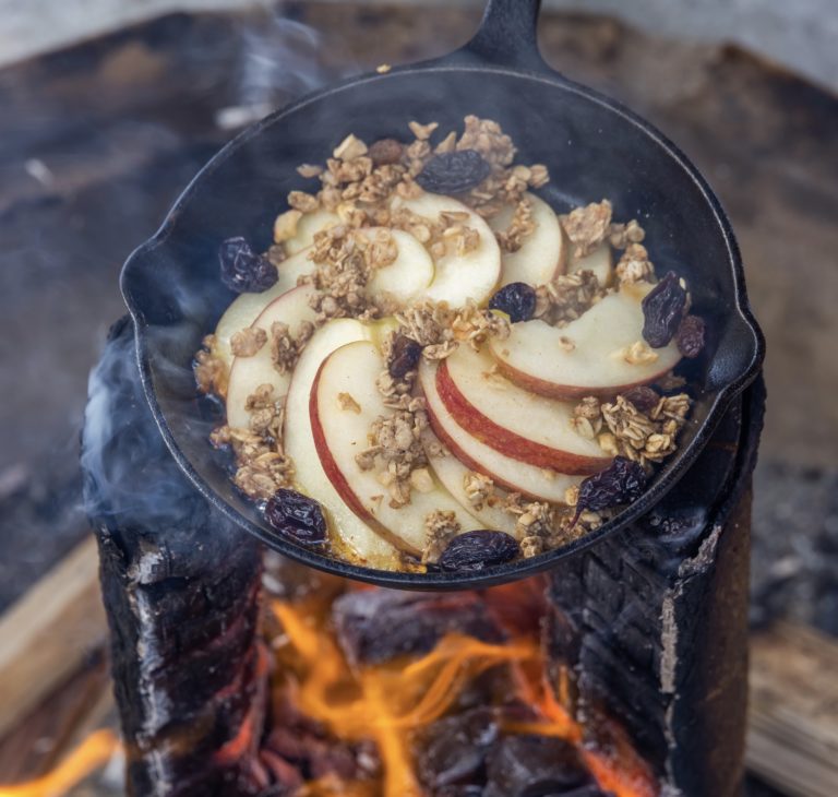 Swedish torch being used to cook breakfast porridge